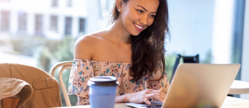 SEO Virtual Assistant working in a cafe