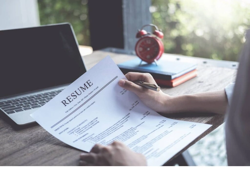 Person reviewing a resume as a process to Hire Virtual Assistant Philippines