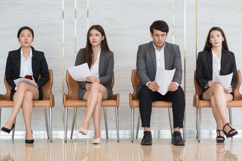 Four people seated in a row representing Hire Virtual Assistant Philippines