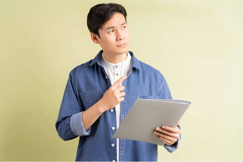 Person holding a folder and pen illustrating the need to Hire Virtual Assistant Philippines